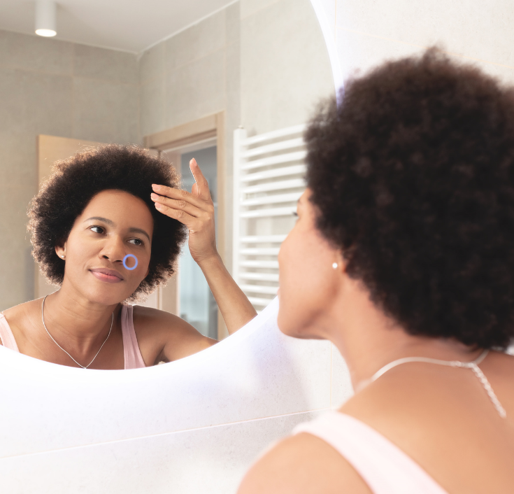 a woman checking out her natural hair in the morning