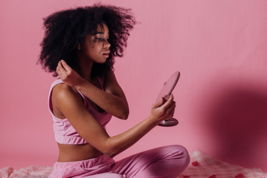 Woman examining different textures throughout her natural hair