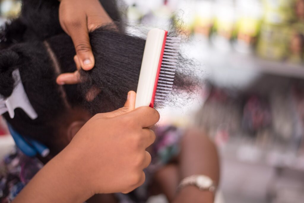 Woman gently detangling healthy natural hair