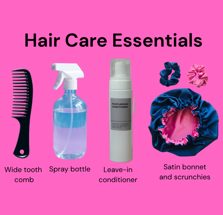 A neatly arranged flat lay of simple 4C hair care essentials including a spray bottle, leave-in conditioner, satin scrunchie, and wide-tooth comb.