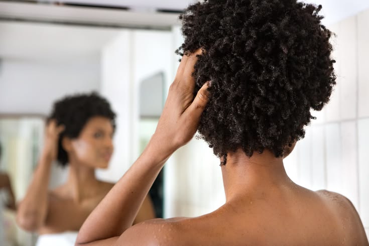 Woman embracing her natural 4C hair journey