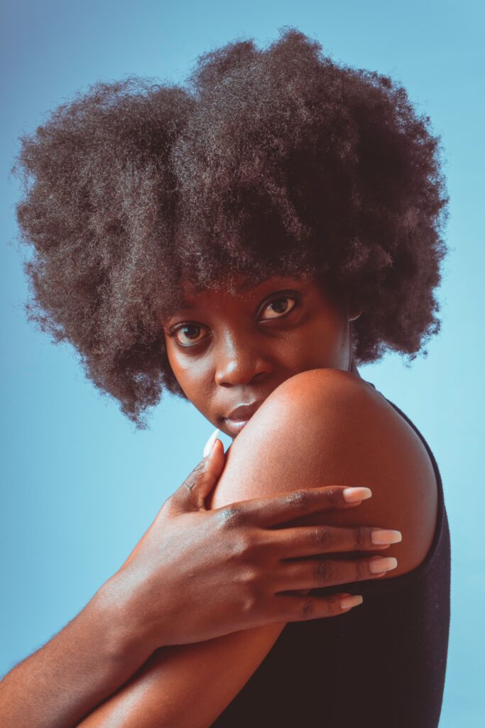 Woman showing healthy thick natural 4C hair