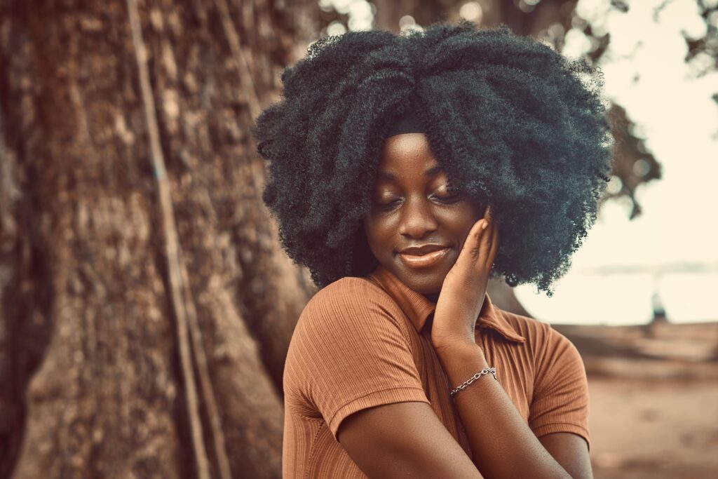 Woman proudly wearing healthy natural 4C hair