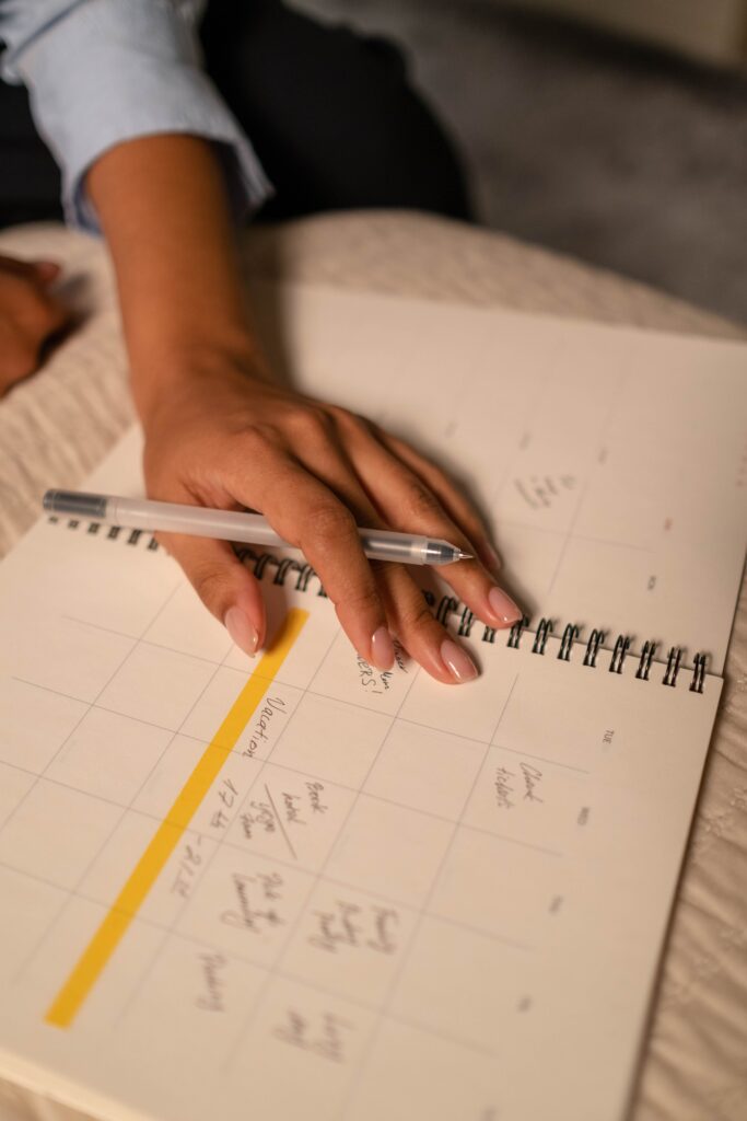 woman writing down her checklist for her monthly hair routine