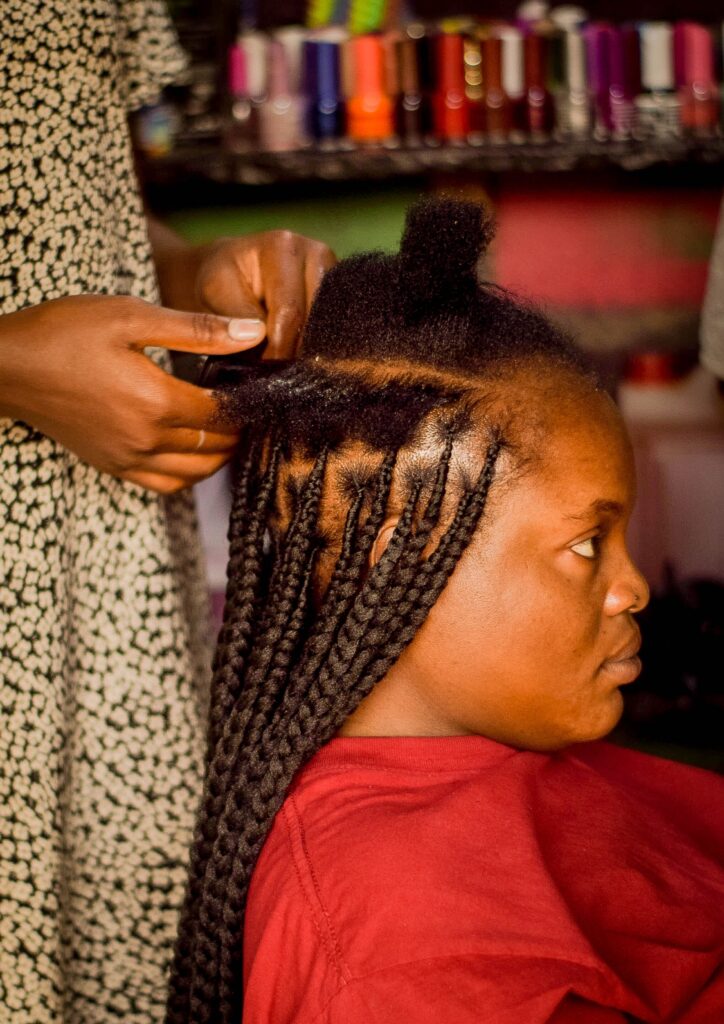 Woman getting a protective hairstyle installed