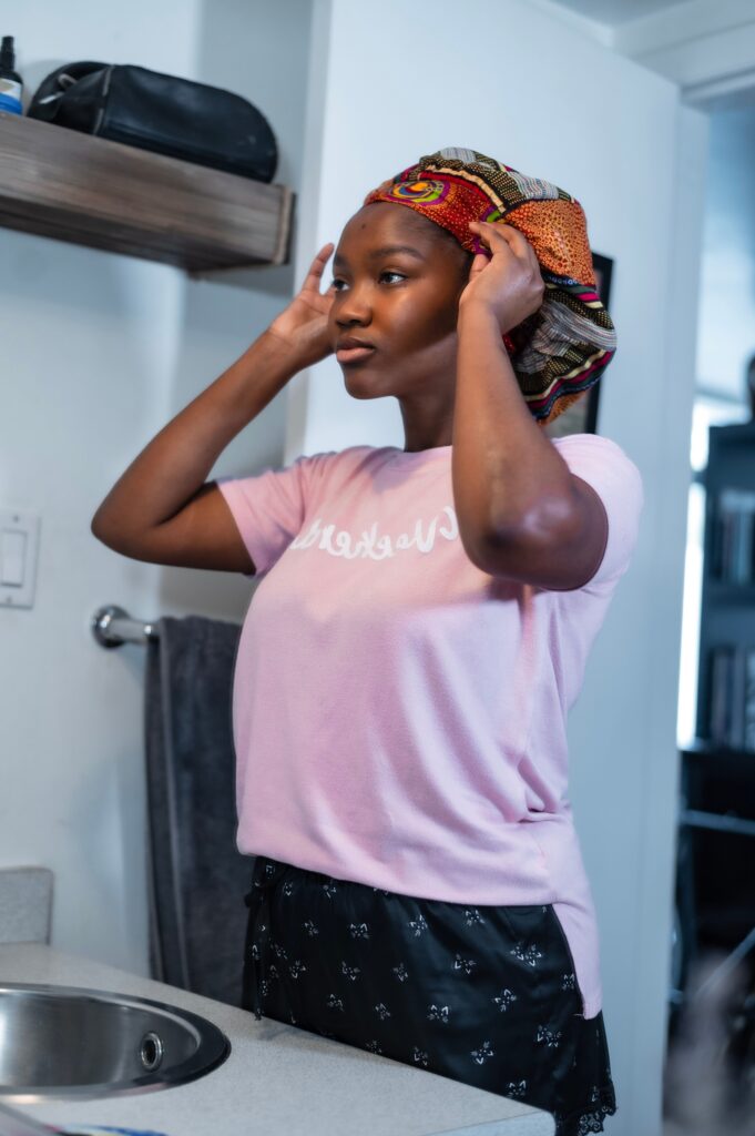Black woman preparing to wash her natural 4C hair on wash day.