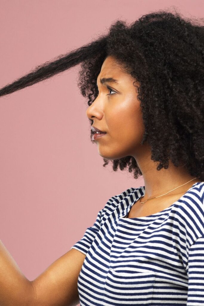 a woman seemingly unhappy with the length of her hair