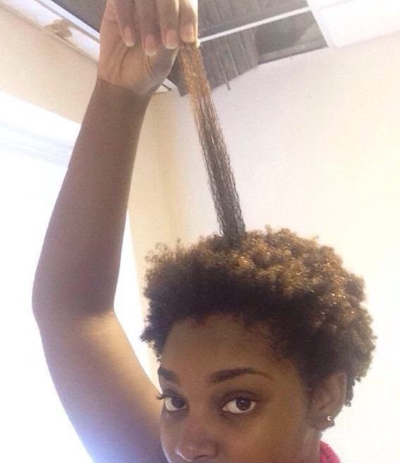 Black woman showing the difference between stretched and shrunken 4C hair
