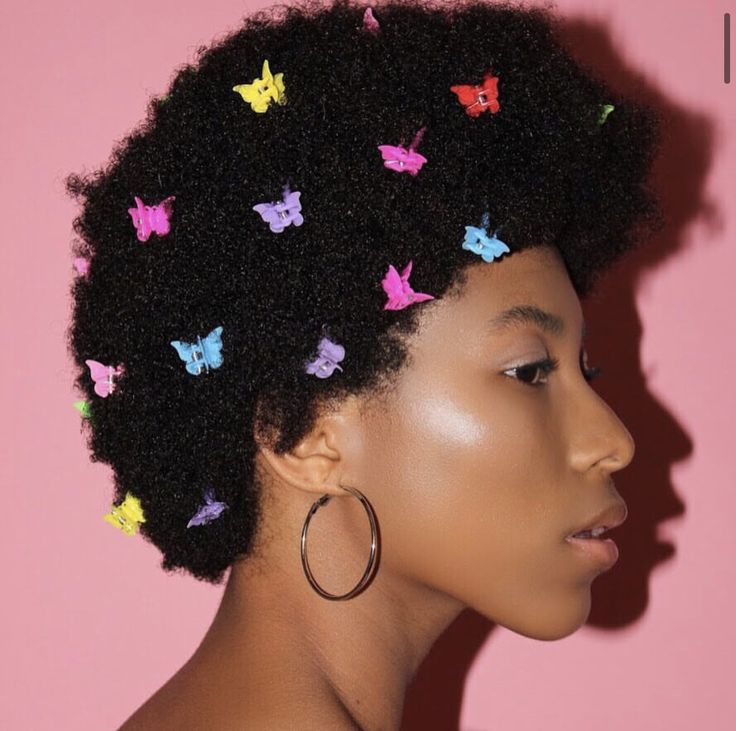 Natural afro styled with decorative hair clips on 4C hair.