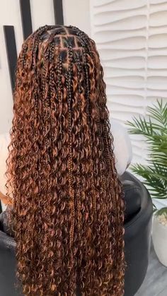 Boho knotless braids with loose curly strands on natural 4C hair.