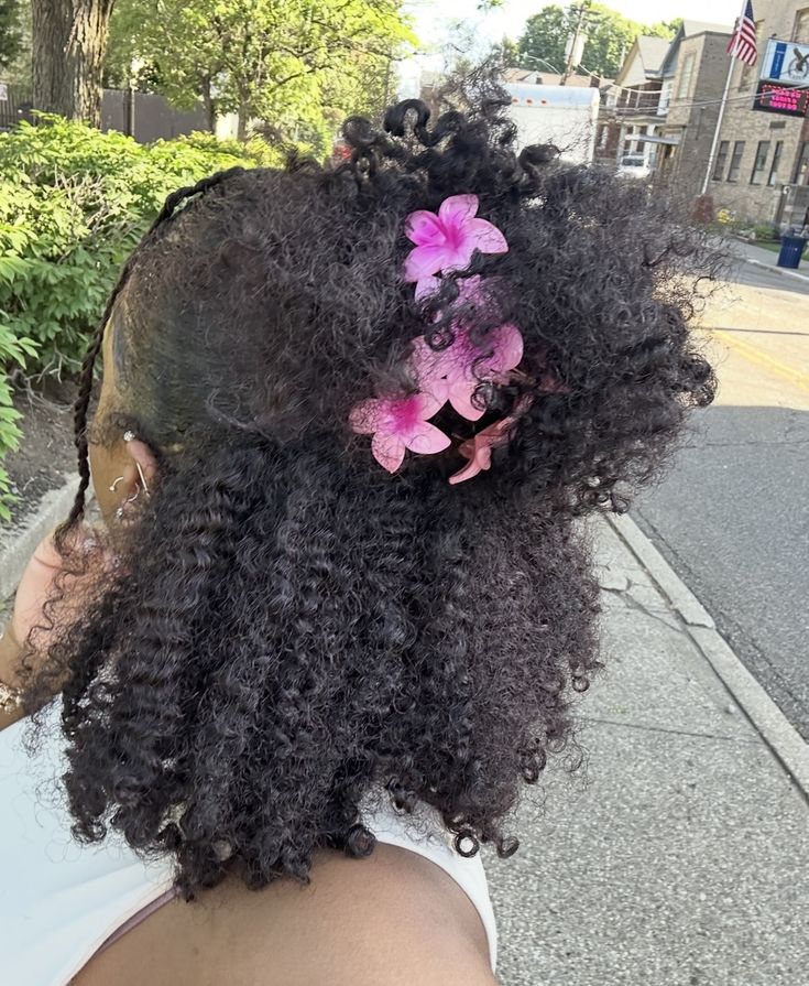 Braid-out with decorative hair clips on natural hair.