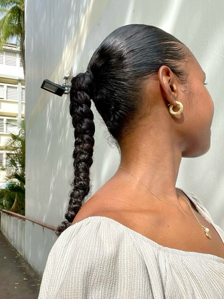 High braided ponytail on natural 4C hair.