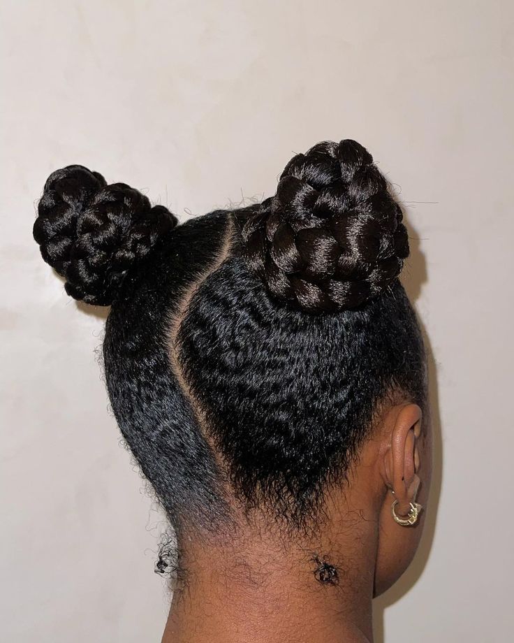 Braided space buns on natural 4C hair.