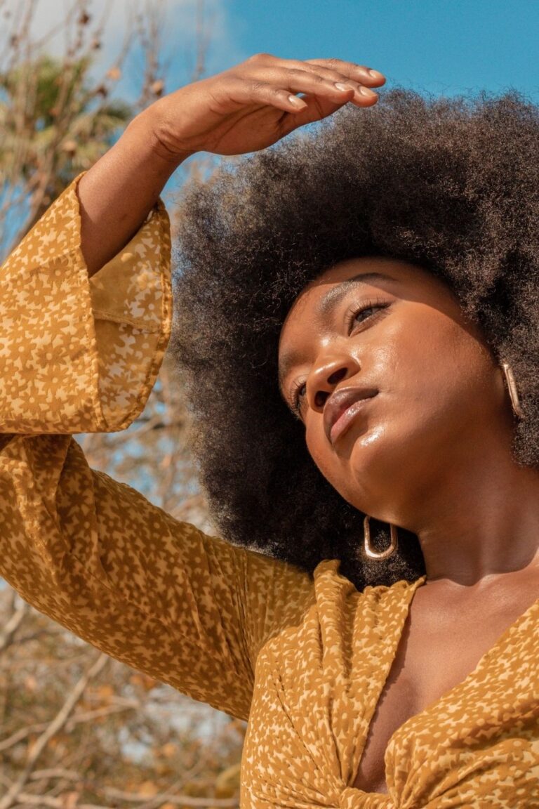 woman with 4c hair on a bright morning