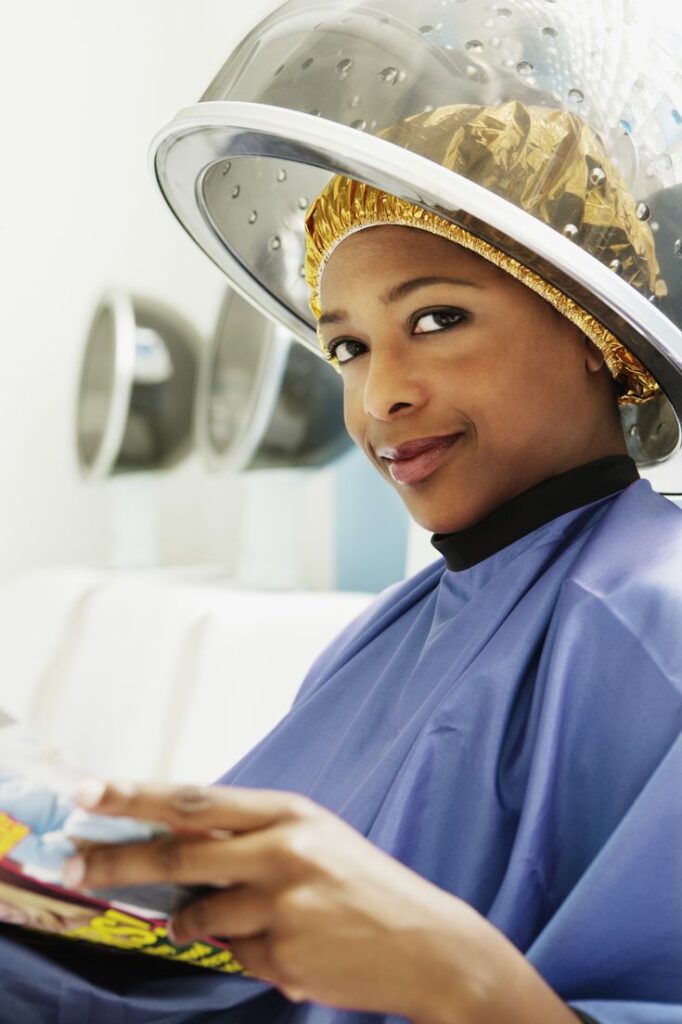 woman using a plastic cap while deep conditioning