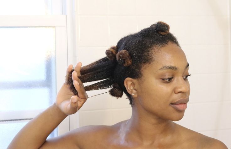 a woman finger detangling her hair