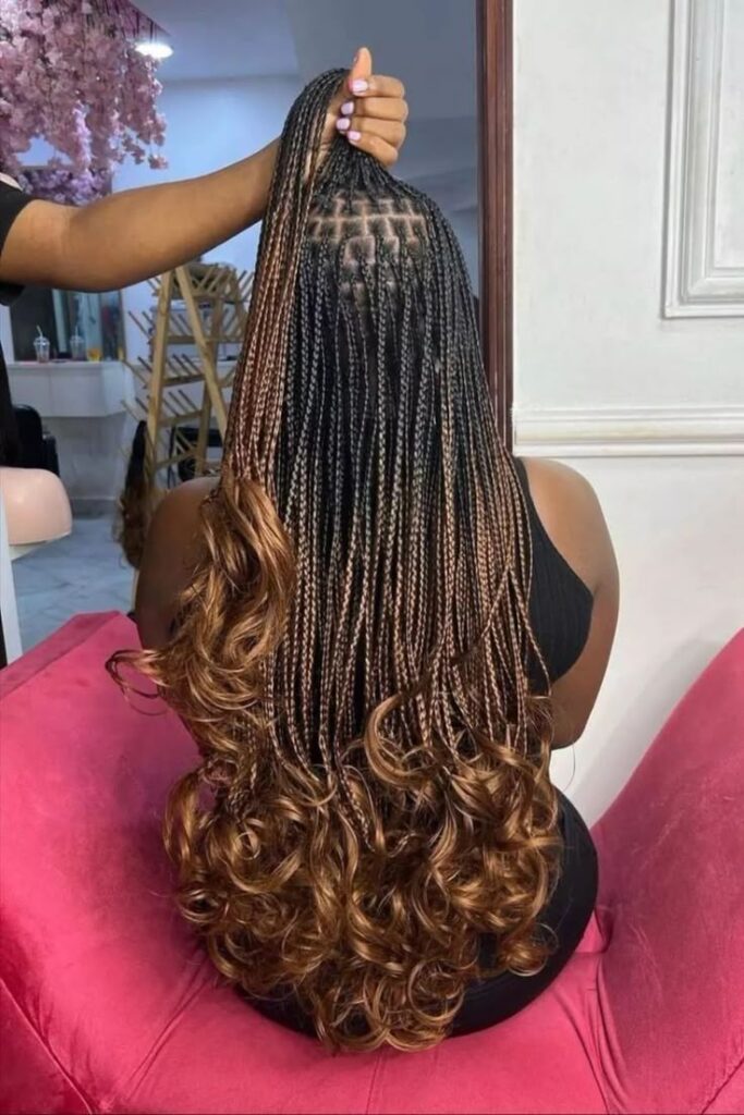 French curl braids with soft curled ends on natural 4C hair.