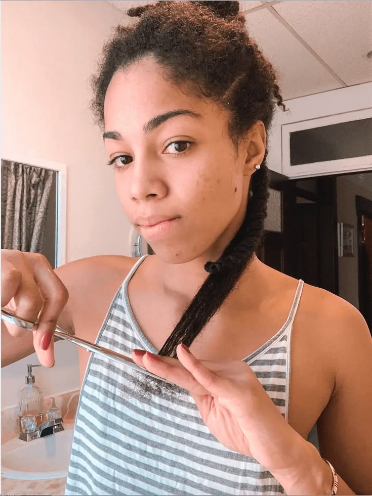 woman trimming her hair
