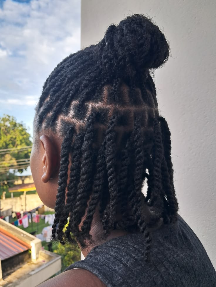 Half-up half-down twists on healthy natural hair.