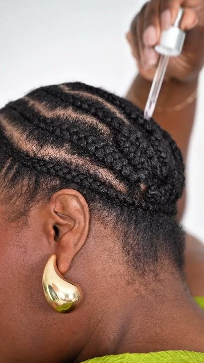 Black woman caring for her protective hairstyle