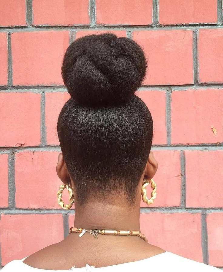 High bun hairstyle on natural kinky hair.