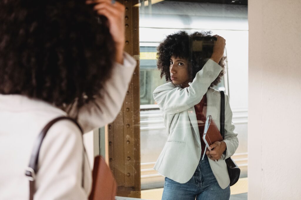 Woman examining her natural hair texture to determine her hair type