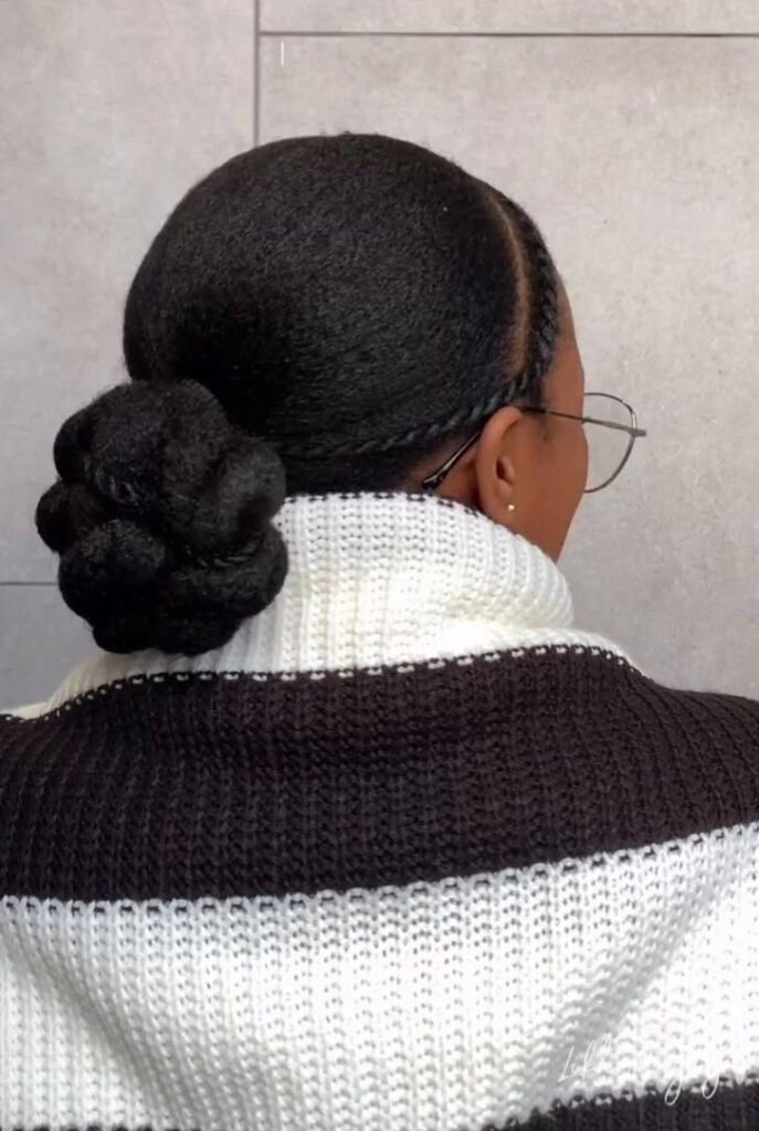 Low twisted bun on natural 4C hair.
