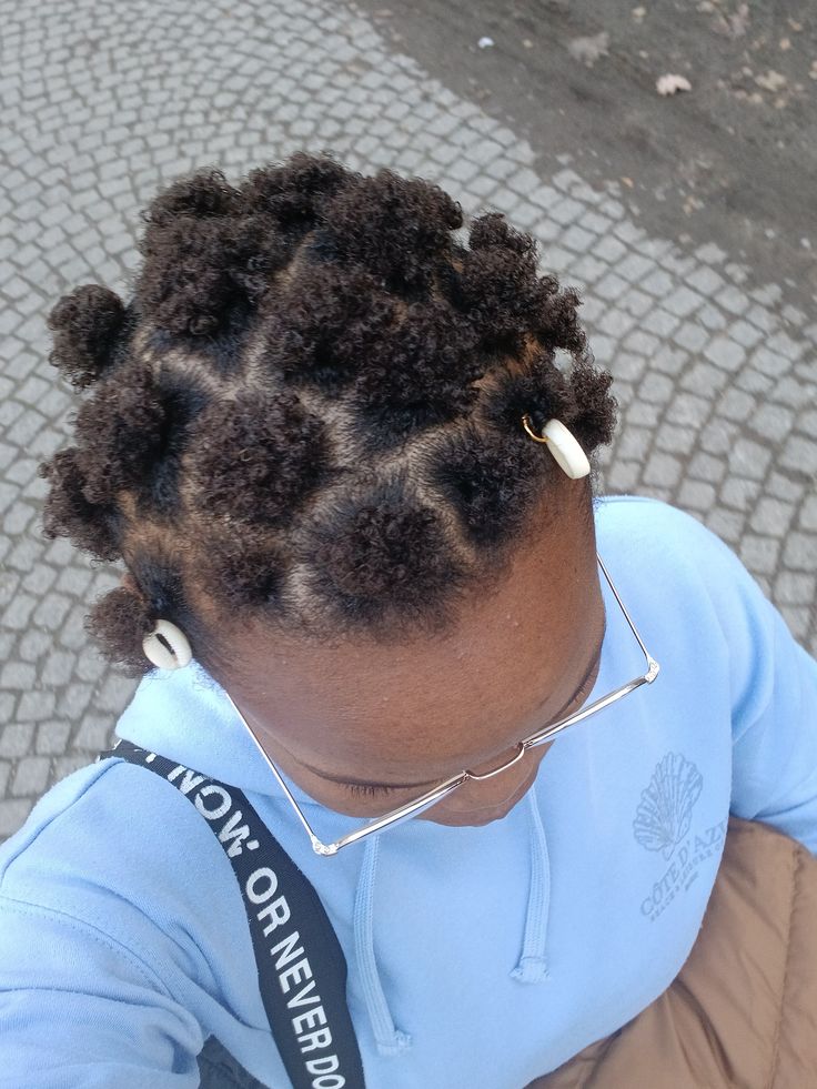 Mini afro puffs on natural 4C hair.