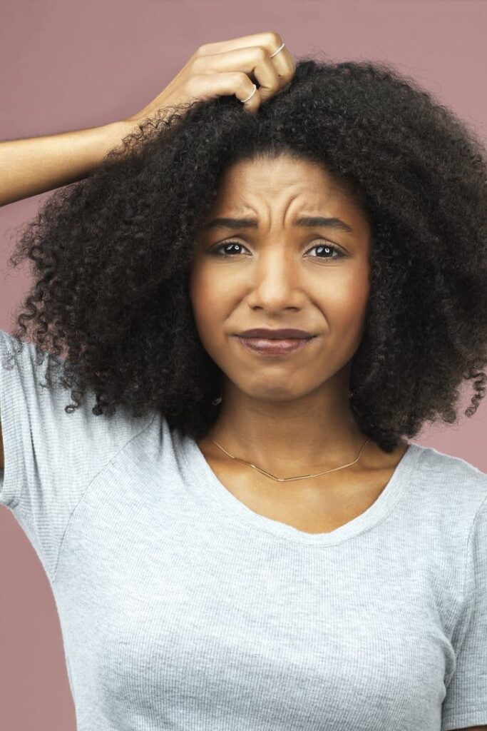a woman itching her hair