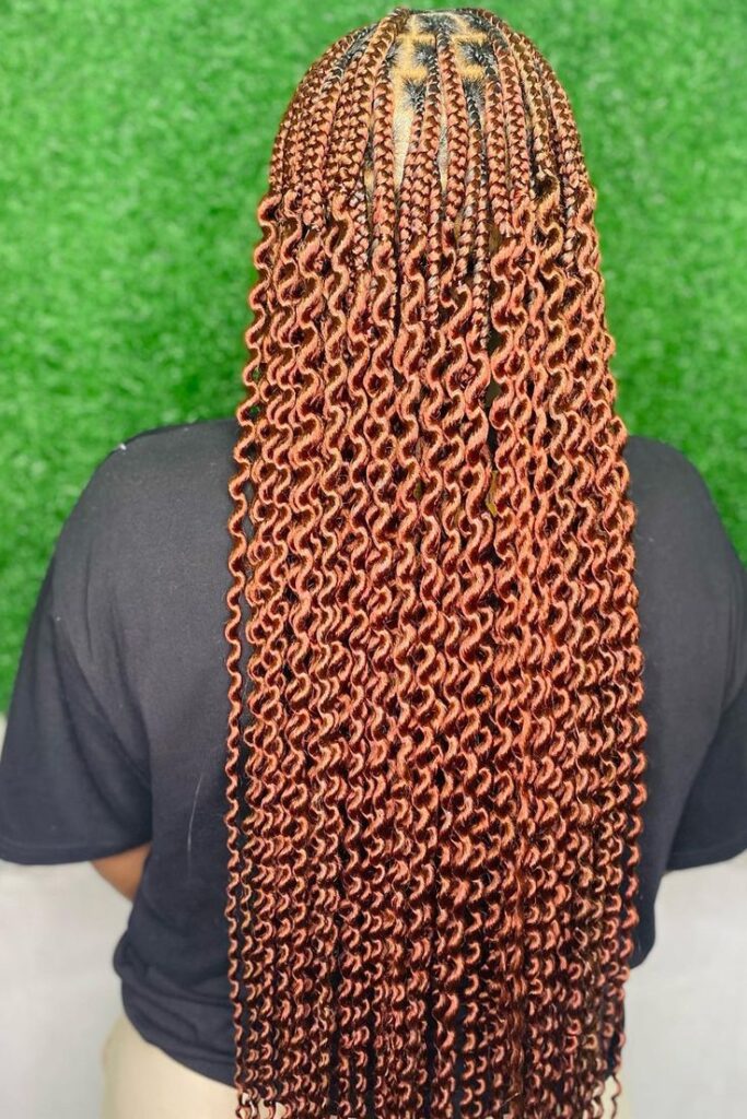 Pick-and-drop braids with loose curls on natural hair.