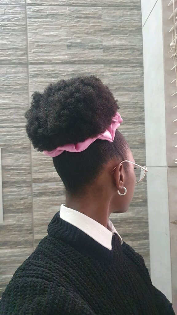 Natural puff with a satin scrunchie on 4C hair.