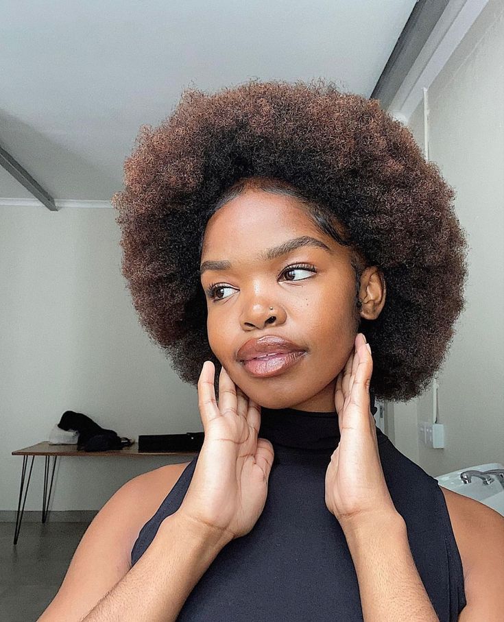 Rounded afro hairstyle on healthy 4C hair.