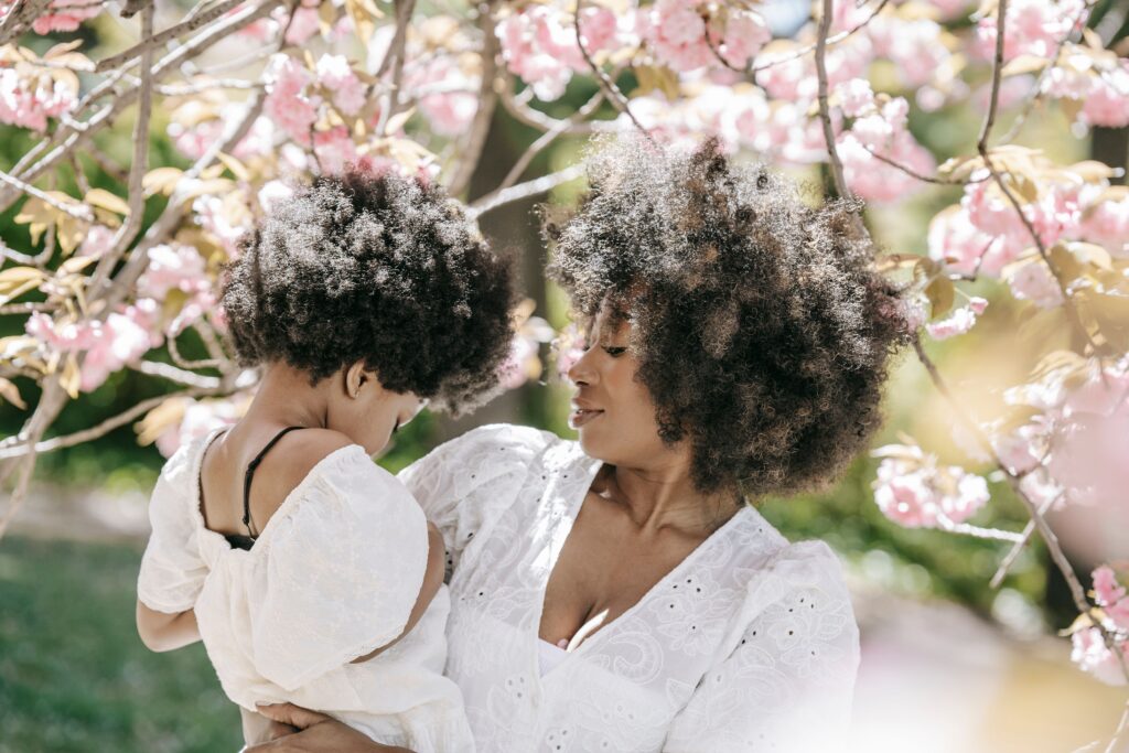 woman and child with afro during summer