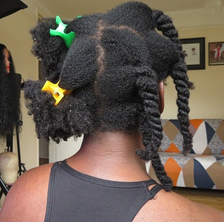 Black woman sectioning her 4C hair before starting wash day.