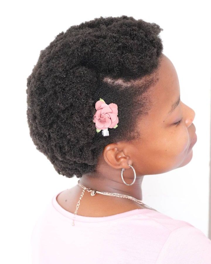 Side-part afro hairstyle on natural 4C hair.