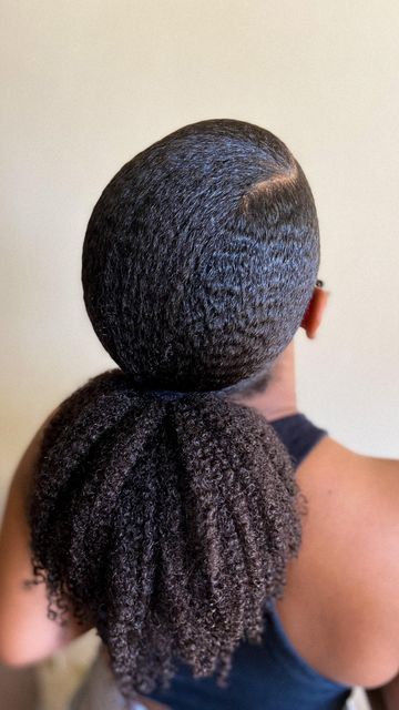 Sleek low ponytail on natural hair.