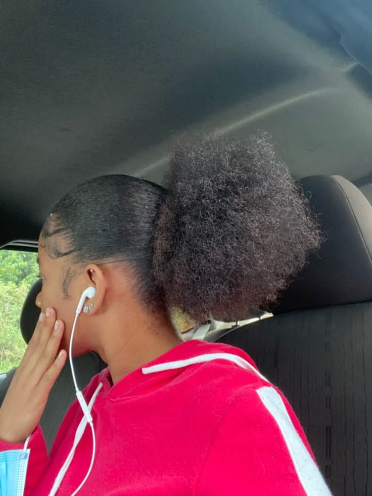 Slicked-back puff hairstyle on natural 4C hair.