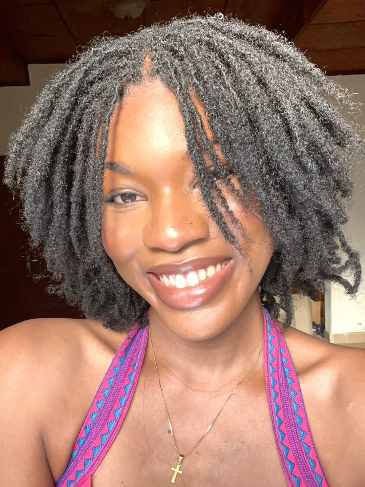 woman on locs smiling
