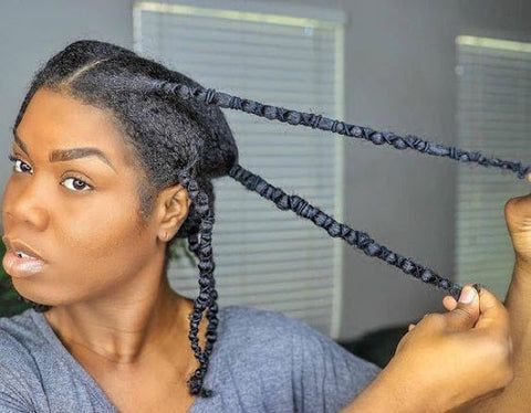 woman naturally stretching her 4c hair