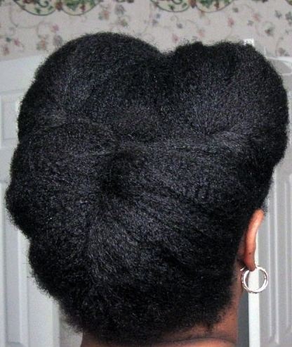 Tucked roll and pin protective style on natural hair.
