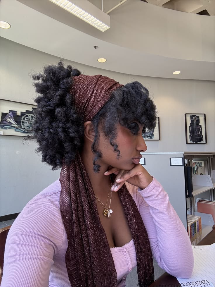 Twist-out style with a satin scarf on natural 4C hair.