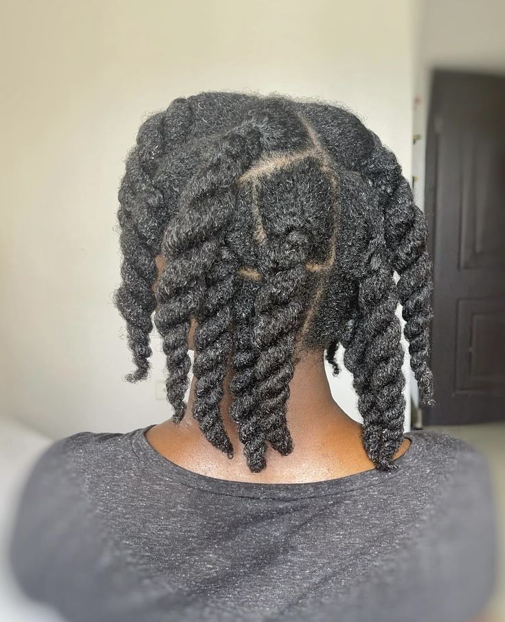 Woman wearing healthy medium twists before her two-week wash day.