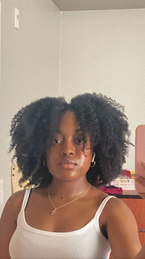 Woman wearing a cute soft braid-out on natural 4C hair
