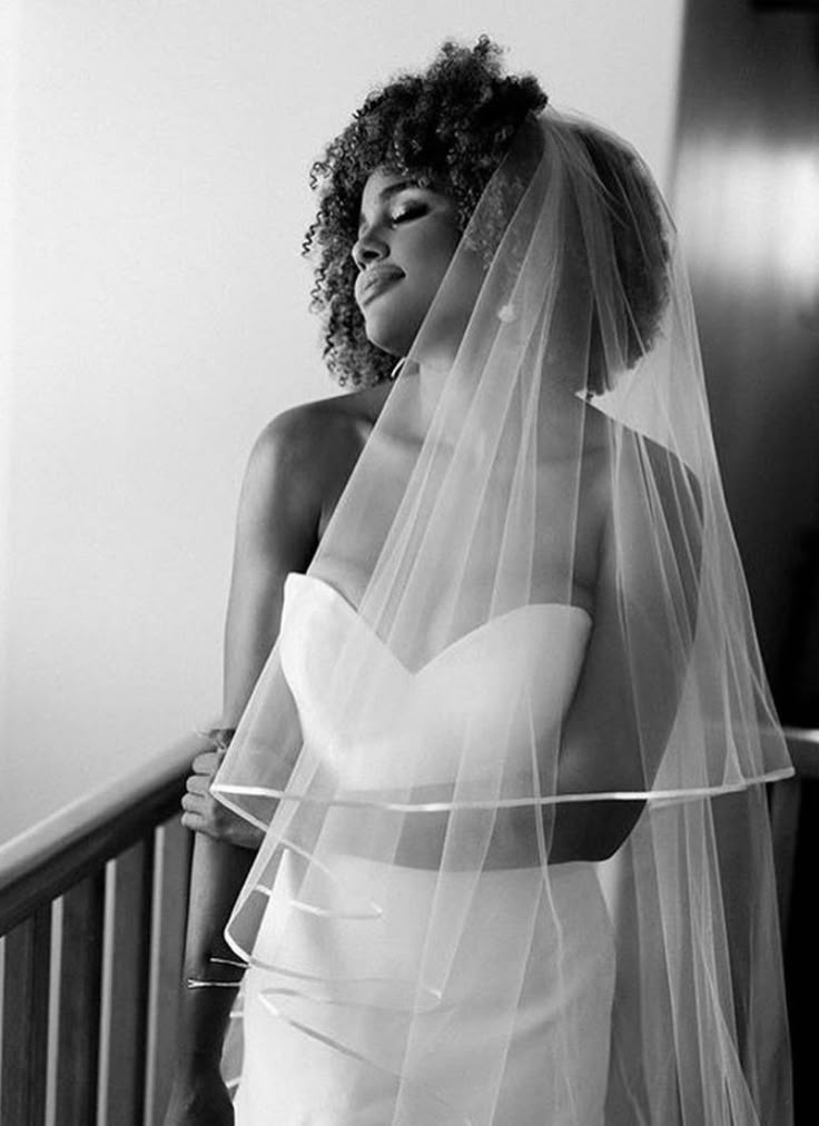 Natural 4C afro styled with a bridal veil