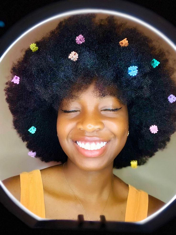 Natural 4C afro decorated with hair clips