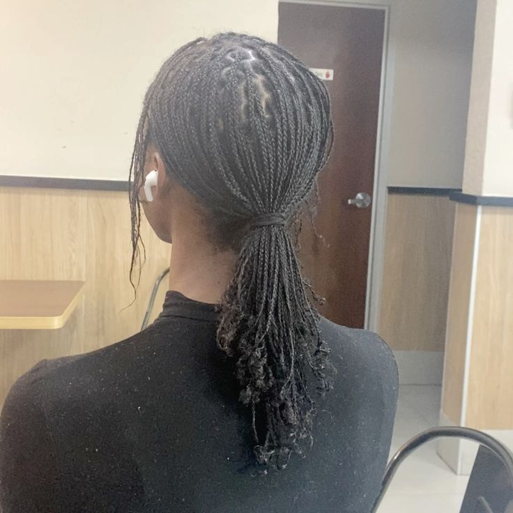 Natural 4C braids gathered into a ponytail