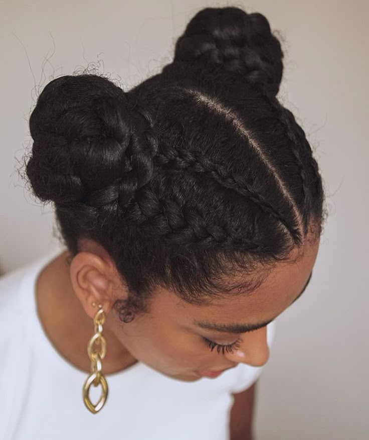 Natural 4C hair styled into braided space buns