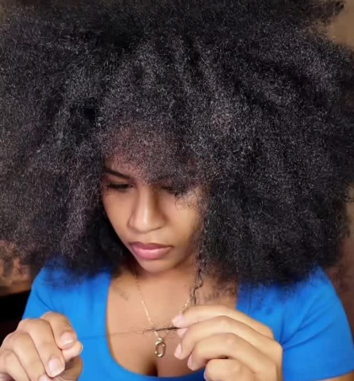 woman observing her hair strand