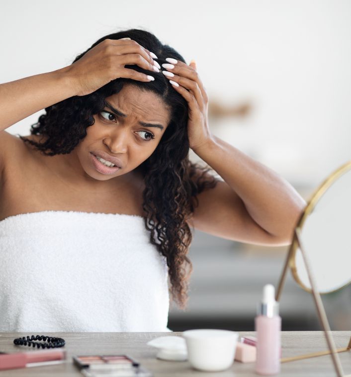 woman checking her hair for product buildup