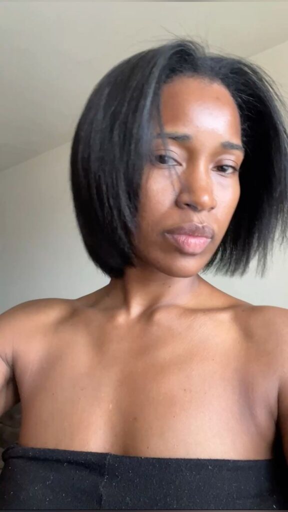 Black woman deciding between a big chop and a long transition to natural hair